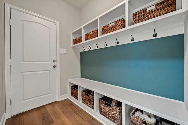 mudroom with baseboards and wood finished floors
