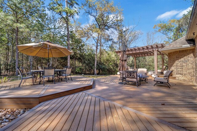 wooden terrace with a pergola and outdoor dining space