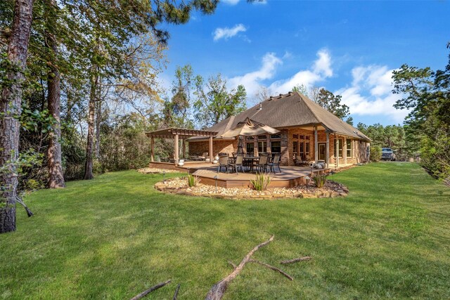 exterior space with a pergola, a lawn, and a deck