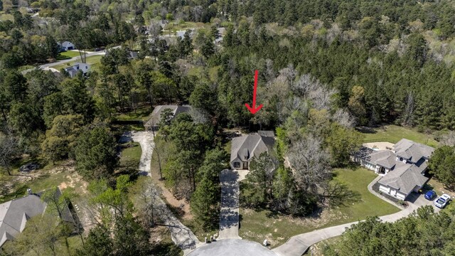 birds eye view of property featuring a residential view and a wooded view