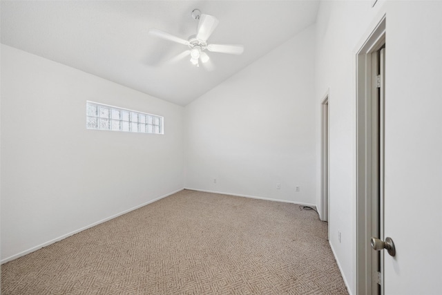 spare room with lofted ceiling, light carpet, a ceiling fan, and baseboards