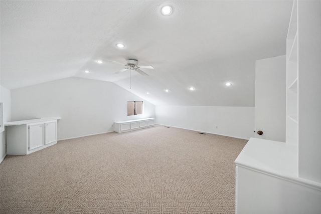 additional living space featuring lofted ceiling, recessed lighting, ceiling fan, and light colored carpet
