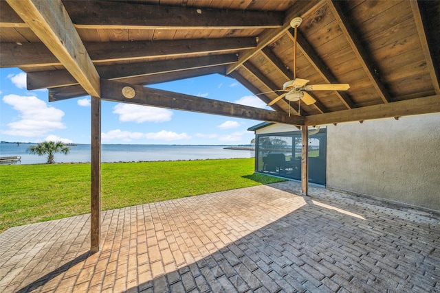 view of patio with a water view and a ceiling fan
