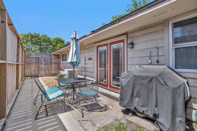 4006 Blalock Rd, Houston, TX 77080 - view of patio / terrace with a grill, fence, central AC, outdoor dining area, and french doors