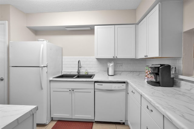 4006 Blalock Rd, Houston, TX 77080 - kitchen featuring a sink, decorative backsplash, white appliances, white cabinetry, and light stone countertops
