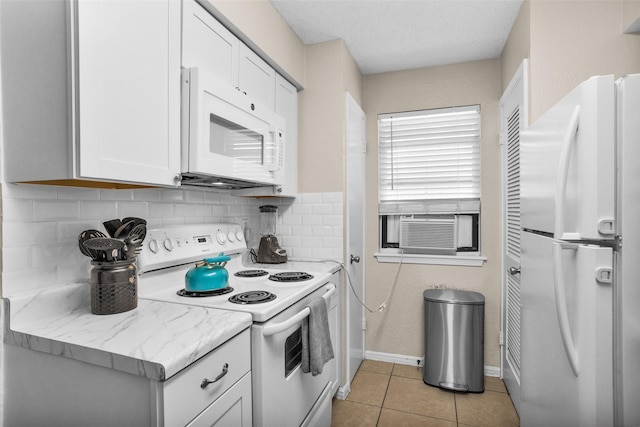 4006 Blalock Rd, Houston, TX 77080 - kitchen featuring white appliances, light tile patterned flooring, baseboards, decorative backsplash, and white cabinetry