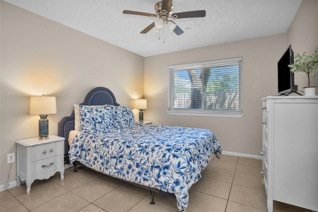 4006 Blalock Rd, Houston, TX 77080 - bedroom featuring a ceiling fan, baseboards, a textured ceiling, and light tile patterned flooring
