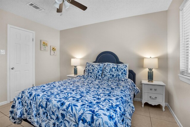 4006 Blalock Rd, Houston, TX 77080 - tiled bedroom featuring a textured ceiling, visible vents, baseboards, and ceiling fan