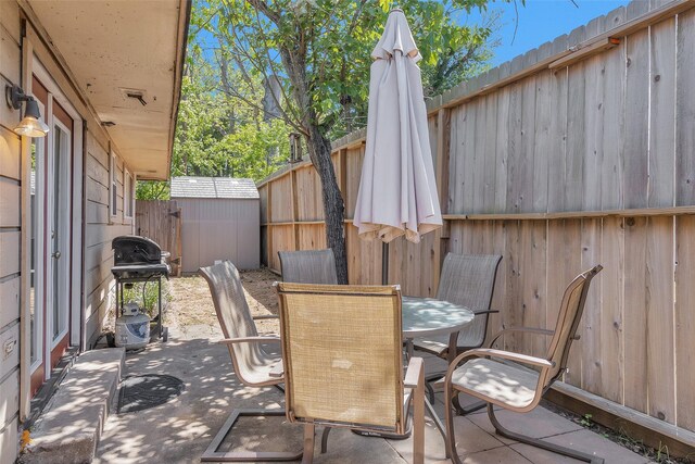 4006 Blalock Rd, Houston, TX 77080 - view of patio with a fenced backyard, a storage shed, grilling area, an outdoor structure, and outdoor dining area