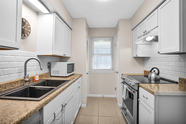 4006 Blalock Rd, Houston, TX 77080 - kitchen with under cabinet range hood, backsplash, high end stove, a sink, and white microwave