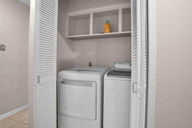 4006 Blalock Rd, Houston, TX 77080 - washroom with washing machine and dryer, baseboards, light tile patterned flooring, and laundry area