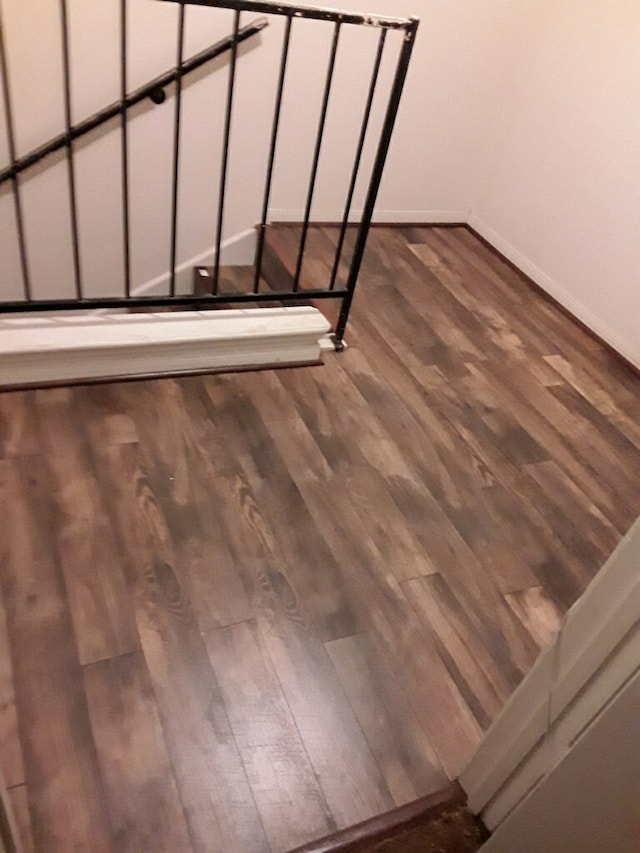 stairs featuring baseboards and wood finished floors