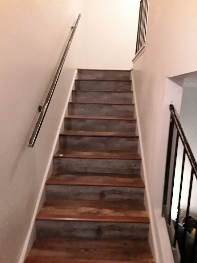 stairway featuring wood finished floors