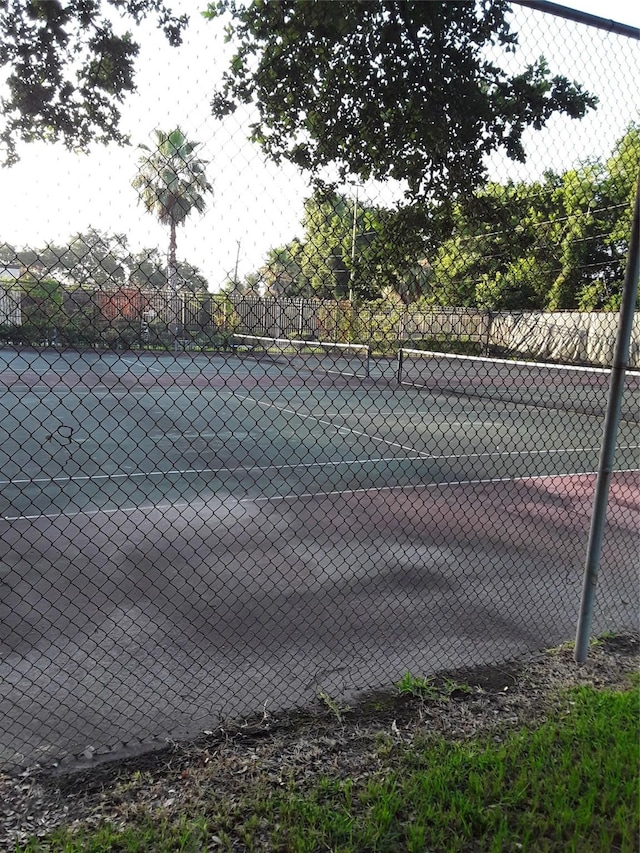 view of tennis court with fence