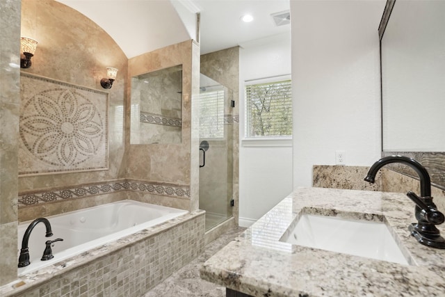 bathroom with a shower stall, a bath, vanity, and visible vents