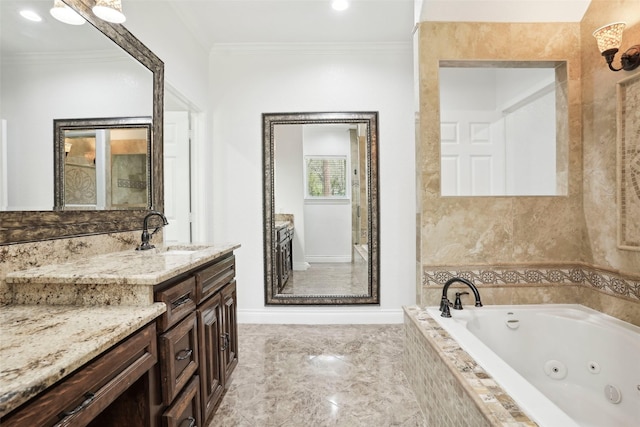 full bath featuring a jetted tub, vanity, baseboards, ornamental molding, and marble finish floor