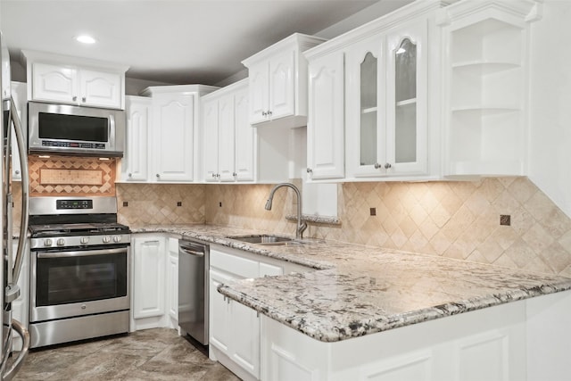 kitchen featuring a sink, glass insert cabinets, white cabinetry, and stainless steel appliances