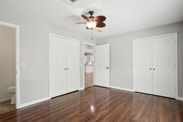 unfurnished bedroom featuring a closet, ceiling fan, baseboards, and dark wood finished floors