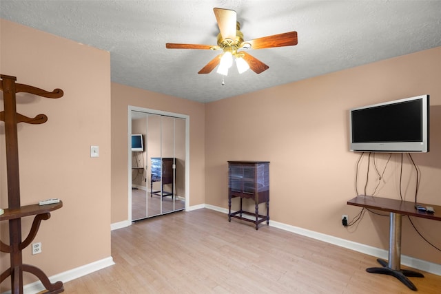 10522 Gulfstream Ln, Sugar Land, TX 77498 - living area with ceiling fan, wood finished floors, a textured ceiling, and baseboards