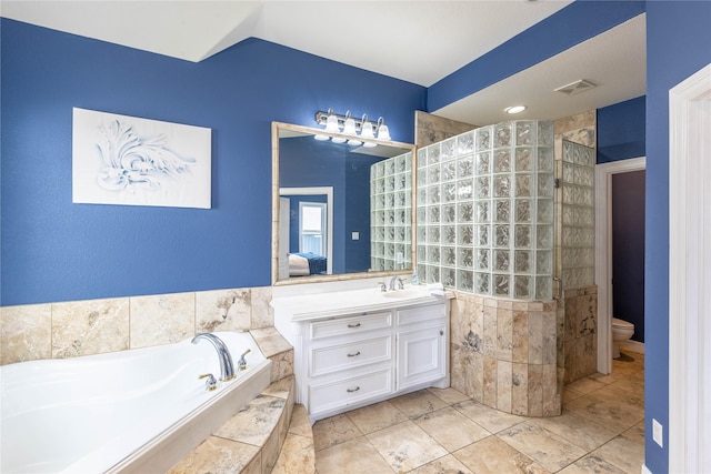98 Victoria Dr W, Montgomery, TX 77356 - bathroom with toilet, vanity, lofted ceiling, a bath, and visible vents