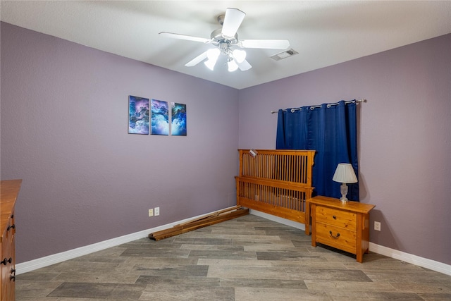 98 Victoria Dr W, Montgomery, TX 77356 - bedroom featuring baseboards, visible vents, wood finished floors, and a ceiling fan