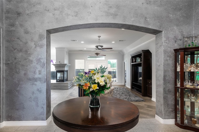 98 Victoria Dr W, Montgomery, TX 77356 - interior space featuring light tile patterned flooring, baseboards, crown molding, and arched walkways