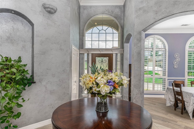 98 Victoria Dr W, Montgomery, TX 77356 - foyer featuring visible vents, ornamental molding, wood finished floors, arched walkways, and a high ceiling