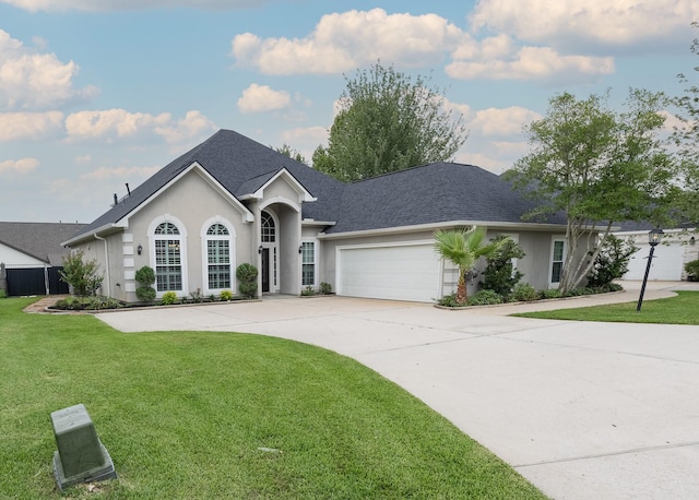 98 Victoria Dr W, Montgomery, TX 77356 - view of front of property with concrete driveway, stucco siding, an attached garage, a front yard, and a shingled roof