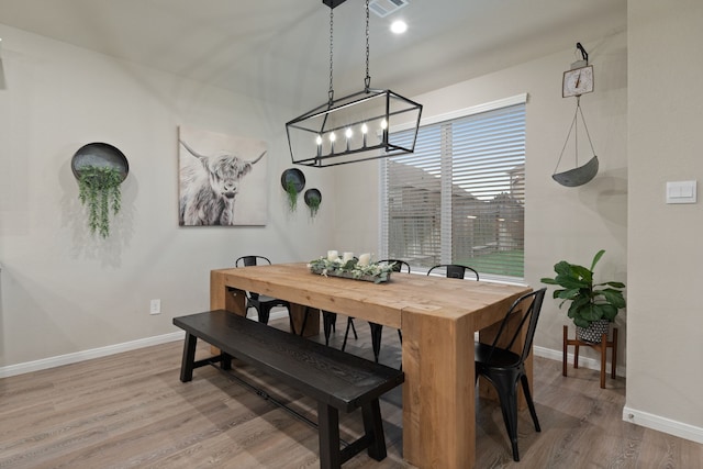 1144 Courteous Creek Dr, Montgomery, TX 77316 - dining area featuring baseboards, wood finished floors, and a chandelier