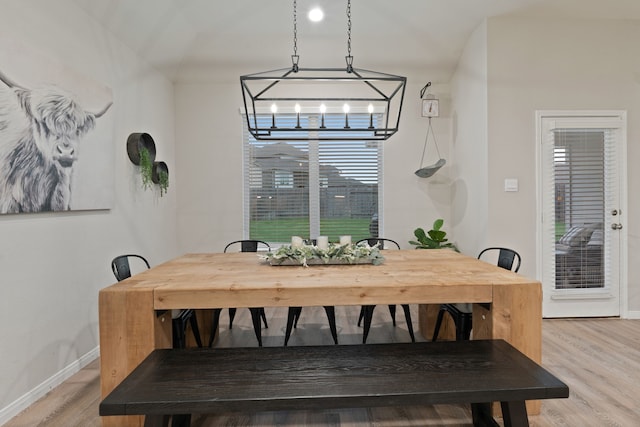 1144 Courteous Creek Dr, Montgomery, TX 77316 - dining area with baseboards, light wood finished floors, and a chandelier