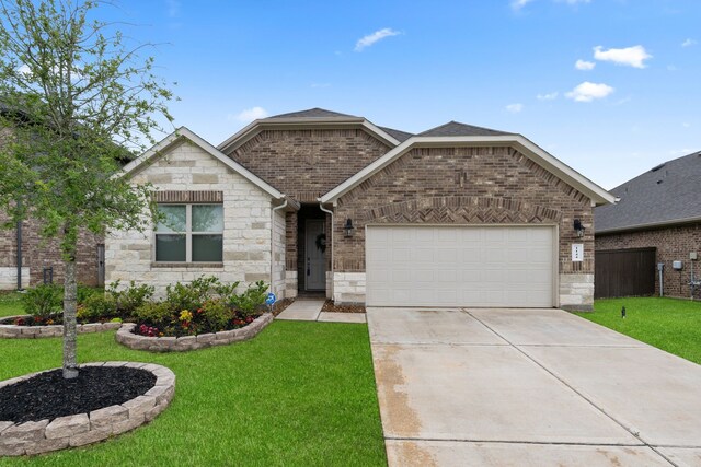 1144 Courteous Creek Dr, Montgomery, TX 77316 - view of front of property with a front lawn, an attached garage, driveway, and stone siding