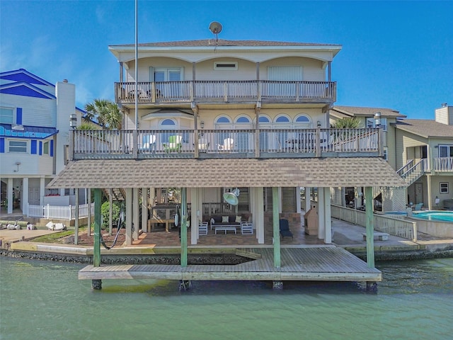 1306 Outrigger, Tiki Island, TX 77554 - rear view of property with a balcony, a patio area, and a water view
