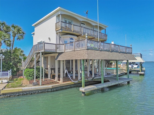 1306 Outrigger, Tiki Island, TX 77554 - dock featuring a balcony, stairs, and a deck with water view