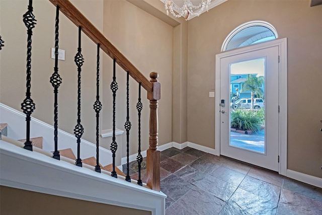 1306 Outrigger, Tiki Island, TX 77554 - entryway with stone tile flooring, baseboards, stairway, and a chandelier