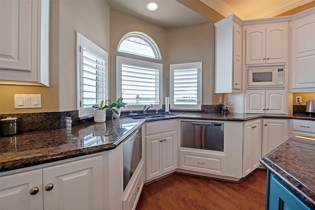 1306 Outrigger, Tiki Island, TX 77554 - kitchen featuring dishwasher, white microwave, white cabinetry, and dark wood-type flooring