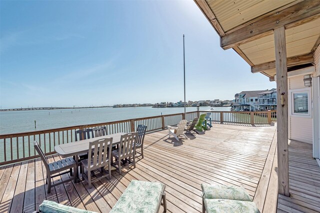 1306 Outrigger, Tiki Island, TX 77554 - wooden terrace featuring outdoor dining space and a water view