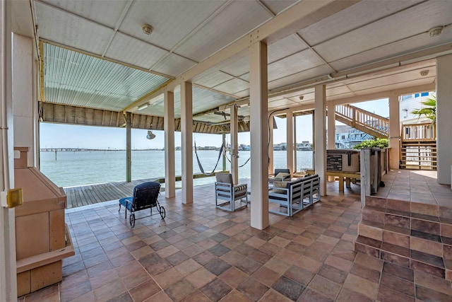 1306 Outrigger, Tiki Island, TX 77554 - view of patio with stairway, a water view, and an outdoor living space