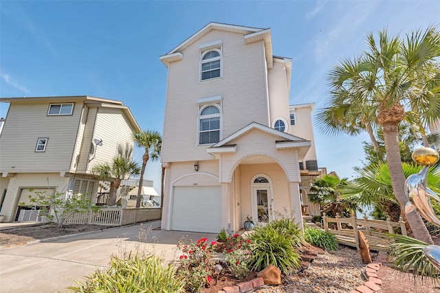 1306 Outrigger, Tiki Island, TX 77554 - coastal inspired home featuring an attached garage and driveway