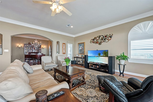 1306 Outrigger, Tiki Island, TX 77554 - living area with arched walkways, a chandelier, ceiling fan, plenty of natural light, and ornamental molding