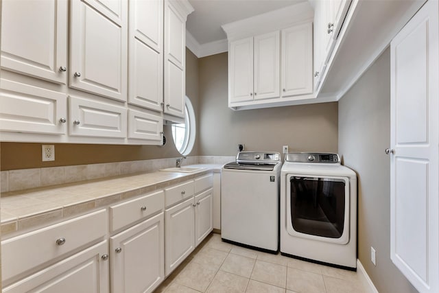 1306 Outrigger, Tiki Island, TX 77554 - washroom featuring washing machine and dryer, cabinet space, light tile patterned floors, and crown molding