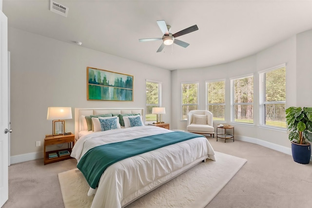 bedroom with visible vents, baseboards, a ceiling fan, and light colored carpet