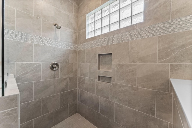 full bath featuring tiled shower