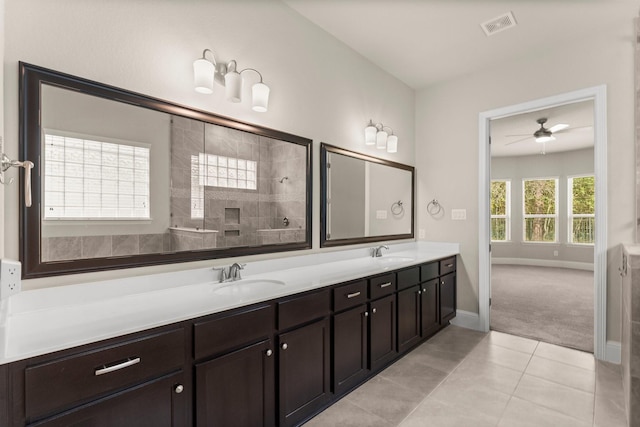 full bath featuring a sink, visible vents, tiled shower, and tile patterned flooring