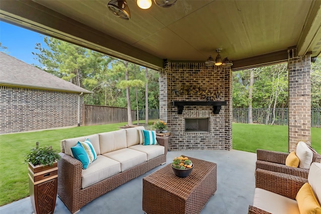 view of patio featuring a fenced backyard, an outdoor living space with a fireplace, and a ceiling fan