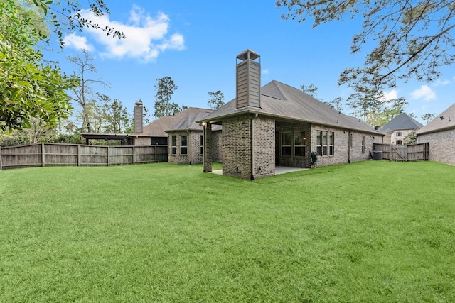 back of house with a yard, brick siding, a fenced backyard, and cooling unit