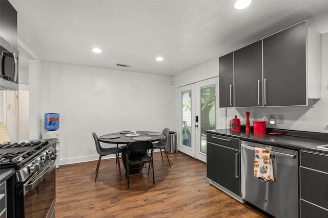 5808 Community Dr, Houston, TX 77005 - kitchen with visible vents, dark countertops, appliances with stainless steel finishes, dark cabinetry, and dark wood-style floors