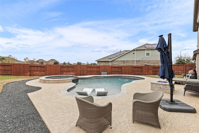 view of pool with a patio, a fire pit, a fenced backyard, and a pool with connected hot tub