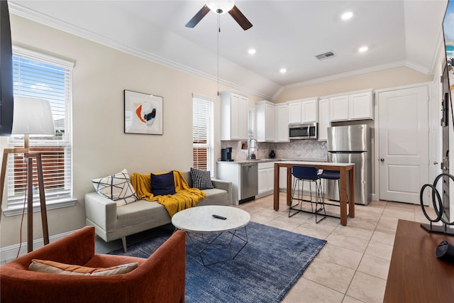living room featuring visible vents, ceiling fan, light tile patterned floors, and a healthy amount of sunlight