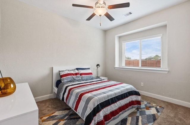 carpeted bedroom featuring visible vents, baseboards, and a ceiling fan