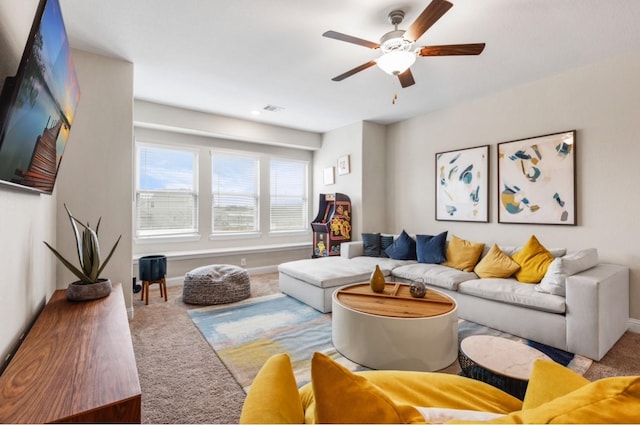carpeted living room featuring ceiling fan, baseboards, and visible vents